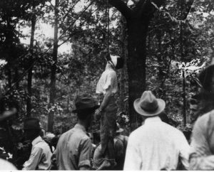 Leo Frank lynched from a tree with surrounding onlookers.