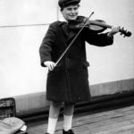 Black and white photograph of Yehudi Menuhin, young, playing violin,