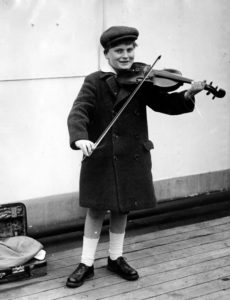 Black and white photograph of Yehudi Menuhin, young, playing violin,